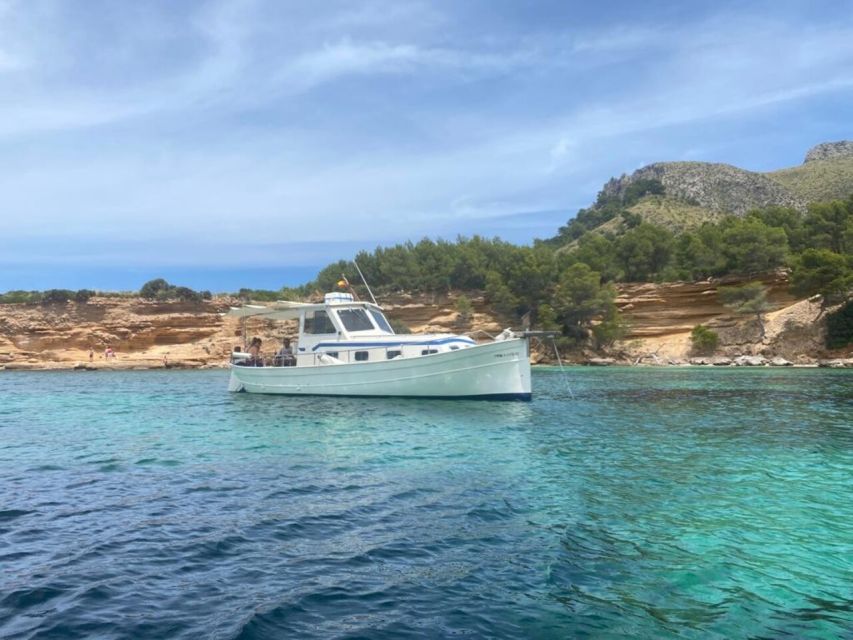 Alcudia: Traditional Wooden Boat Trip with Snorkeling - The north coast by boat: cliffs, caves, and Cap Menorca
