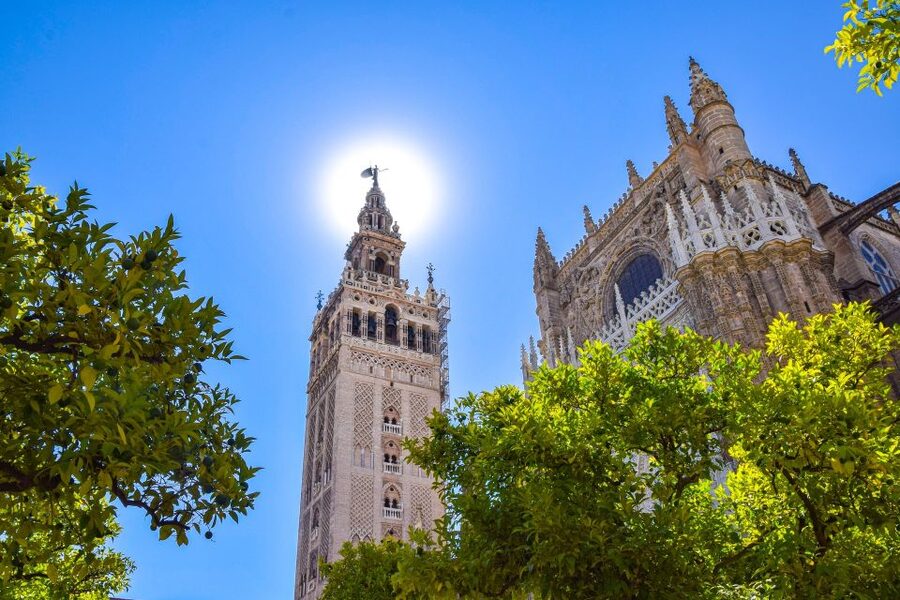 Algarve: Seville Full-Day Shopping and Sightseeing Tour - Crossing Triana Bridge into Seville