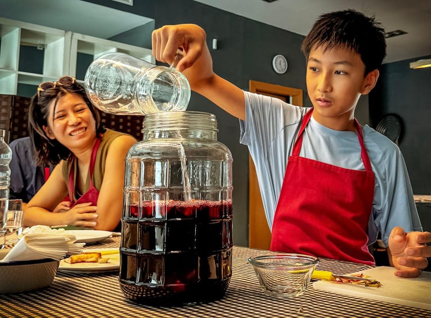 Barcelona: Seafood Paella ★Maestro★ & Tapas & Sangria - Making sangria with fresh fruit