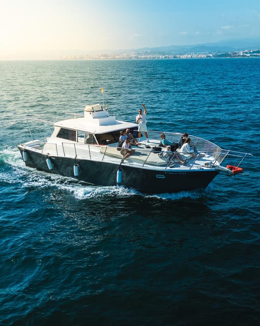 Estepona: Dolphins Searching Sea Cruise with Drink & Snacks - The boat, seating, and onboard mood