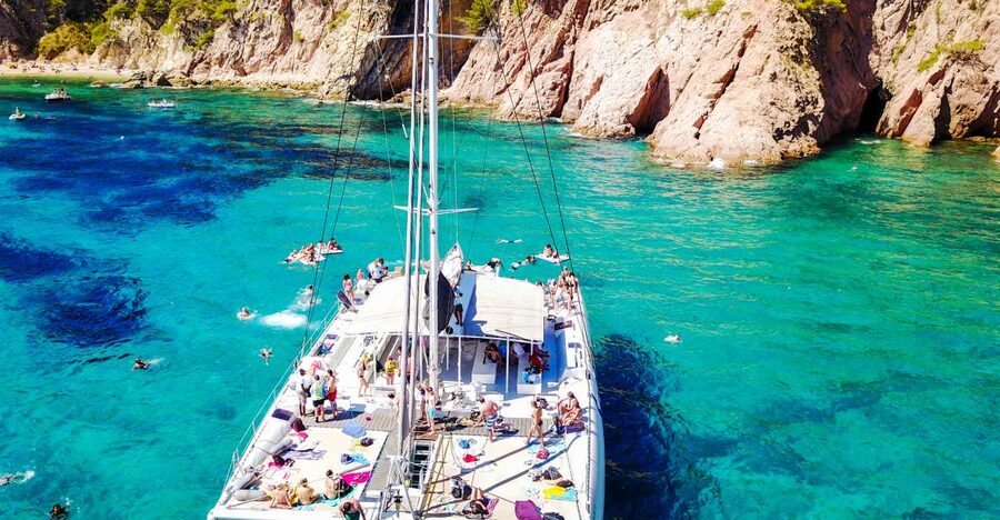 Lloret de Mar: Catamaran Sailing Cruise with BBQ and Drinks - Leaving Lloret de Mar from the beach