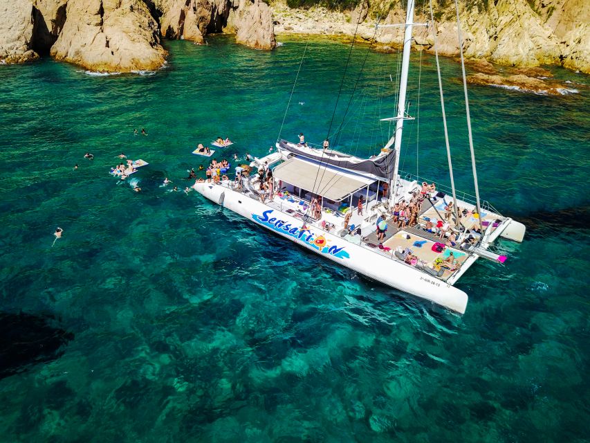 Lloret de Mar: Catamaran Sailing Cruise with BBQ and Drinks - Drinks, dancing, and the return to Lloret