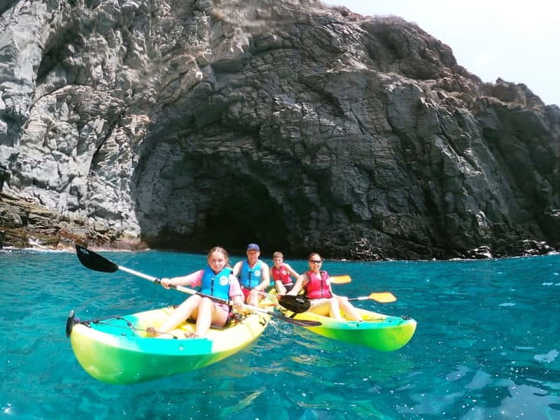 Los Cristianos: Kayak and Snorkel with Turtles and Photos - Entering a sea cave near the cliffs