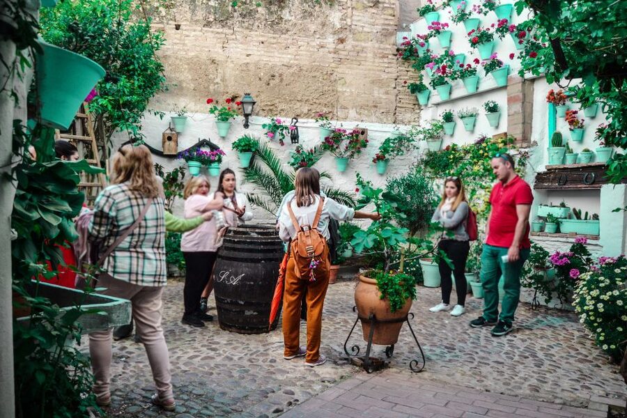 Patios of Cordoba Walking Tour - Walking into San Basilio’s flower-filled courtyards